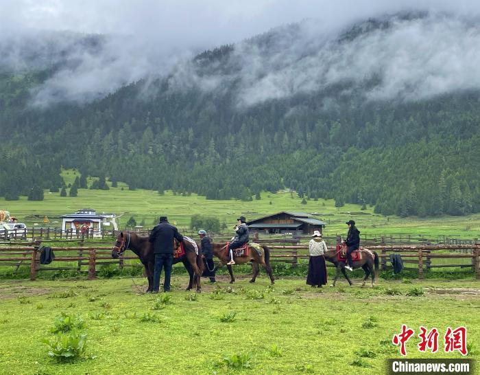 6月10日，游客在魯朗小鎮(zhèn)高山牧場景區(qū)體驗騎馬?！∪轿木?攝